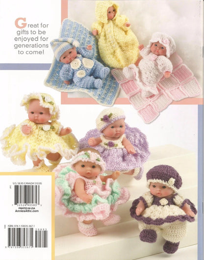 Collection of crocheted baby outfits and dolls on a white background