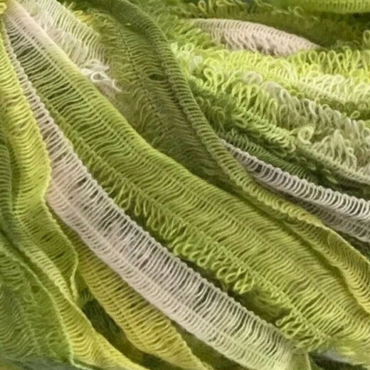 Green skein of yarn with a label on a white background