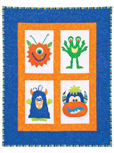 Quilt with colorful monster designs on a blue background