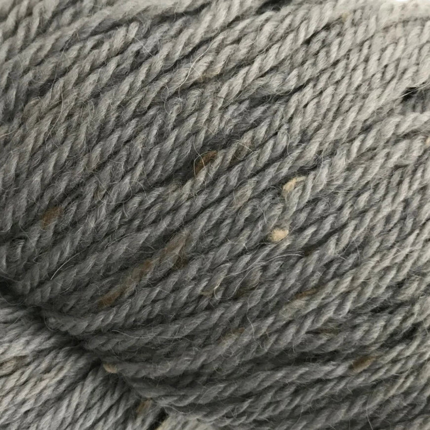 Close-up of a skein of gray yarn on a white background