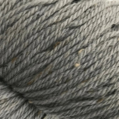 Close-up of a skein of gray yarn on a white background