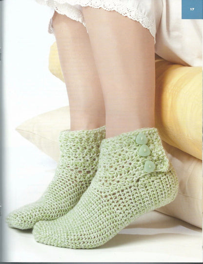 Green crochet socks worn by a person sitting on a yellow cushion.