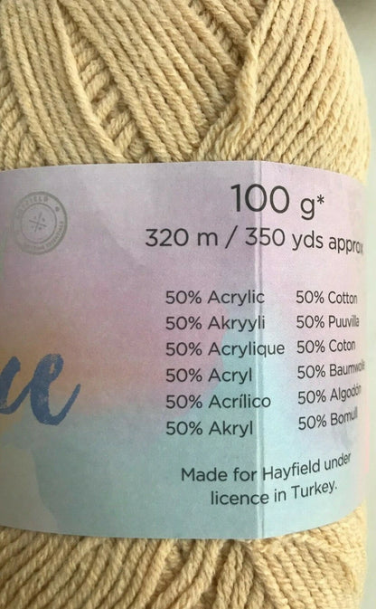 Close-up of a skein of yarn with a label detailing fiber content and product information.