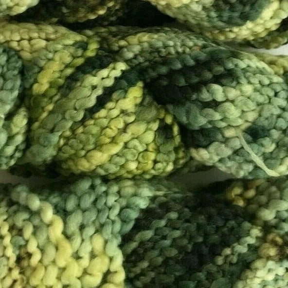 Close-up of green and yellow textured yarn balls
