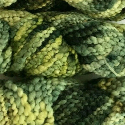 Close-up of green and yellow textured yarn balls