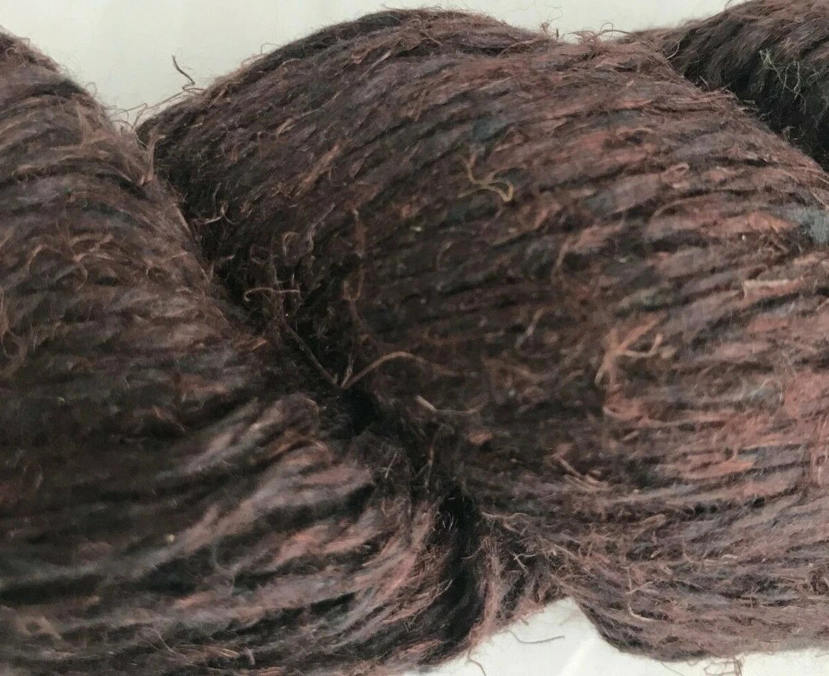 Close-up of dark brown yarn on a white background