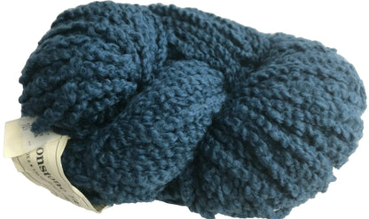 Blue skein of yarn with a small piece of paper inside on a white background