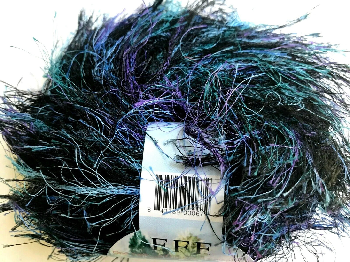 Close-up of a skein of yarn with a brand label partially visible.