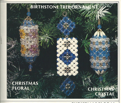 Three beaded Christmas ornaments on a green pine branch with labels for 'Christmas Floral' and 'Christmas Crystal'.
