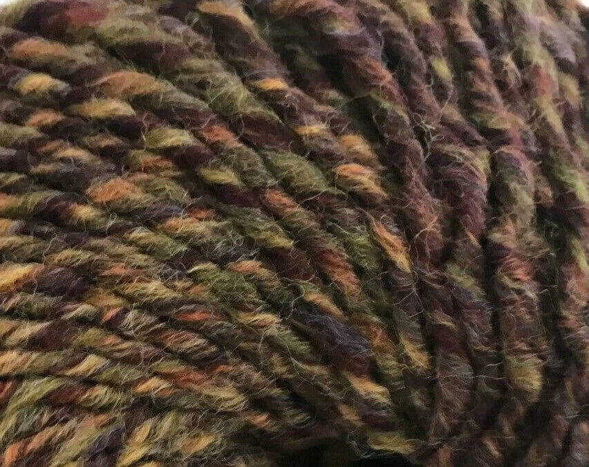 Close-up of a ball of multicolored yarn with earthy tones.