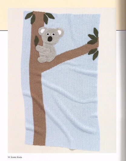 Knitted blanket with a koala design on a tree branch against a light blue background