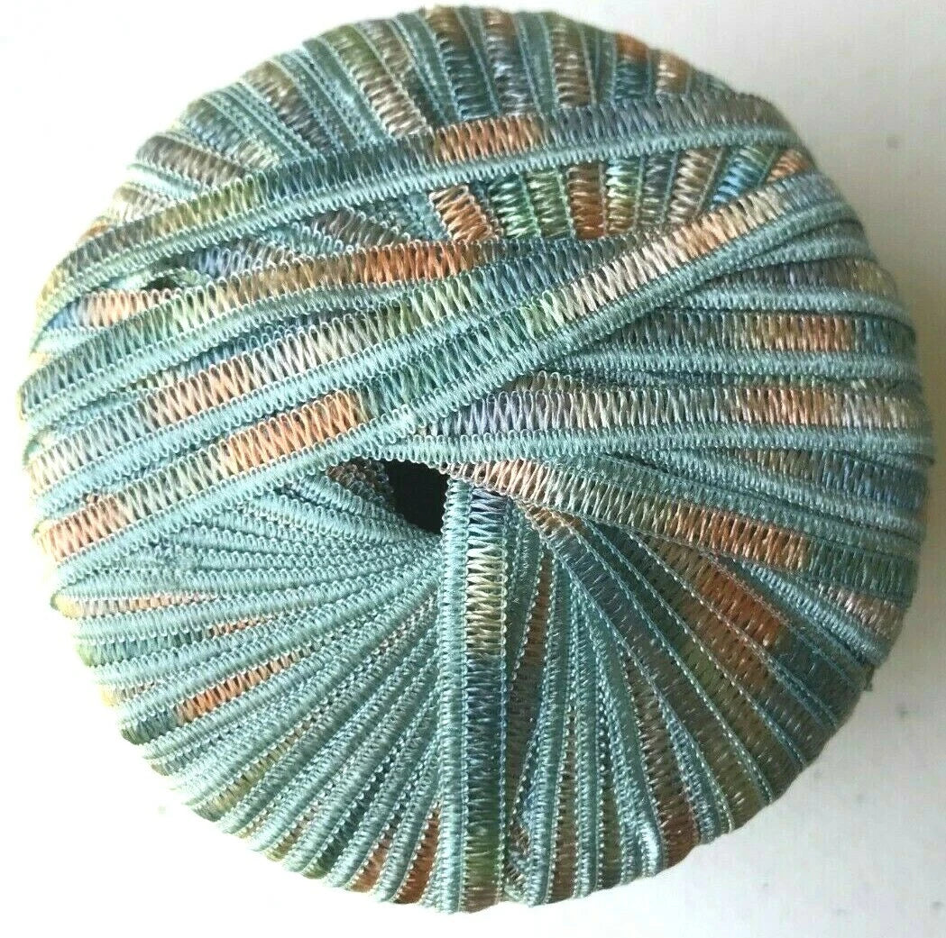 Spool of blue and green yarn on a white background