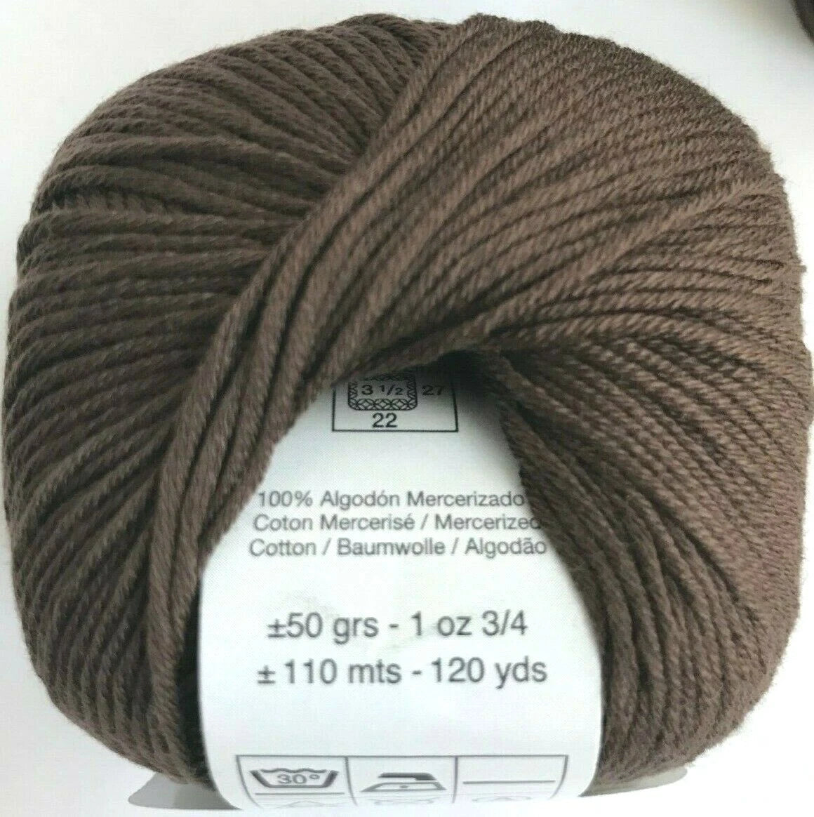 Ball of brown yarn with label on a white background