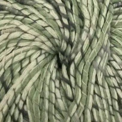 Close-up of a skein of green yarn with a textured pattern.