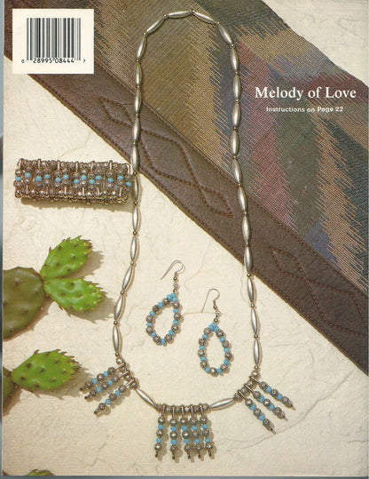 Jewelry set with necklace, earrings, and bracelet on a textured surface with cactus illustration.