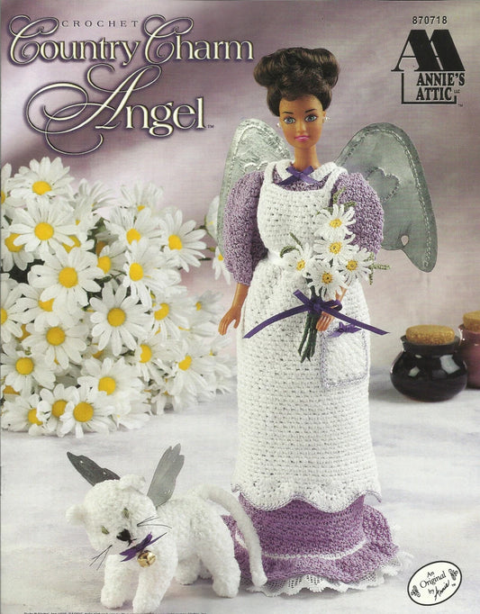 Crocheted angel doll with wings and a rabbit, surrounded by flowers, on Annie's Attic packaging.