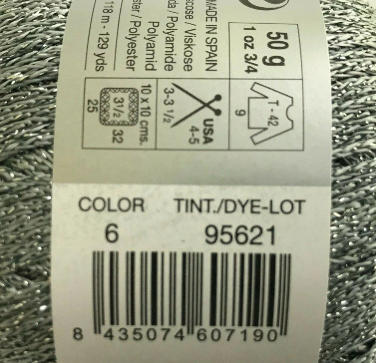 Yarn ball with label showing product details on a white background