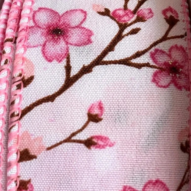 Pouch with cherry blossom design on a white background