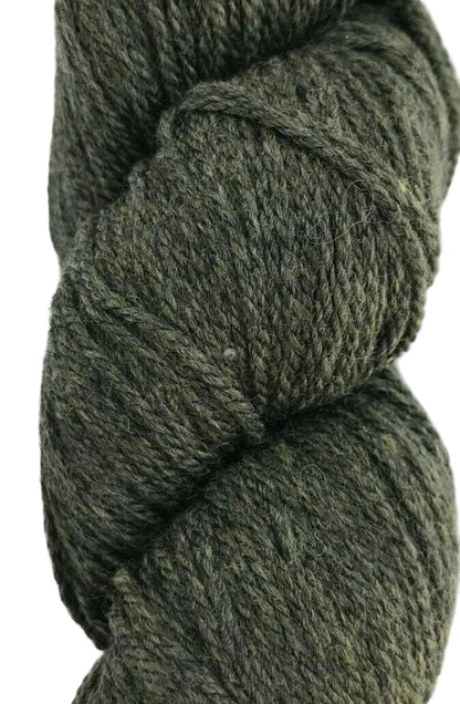Close-up of a skein of dark green yarn on a white background