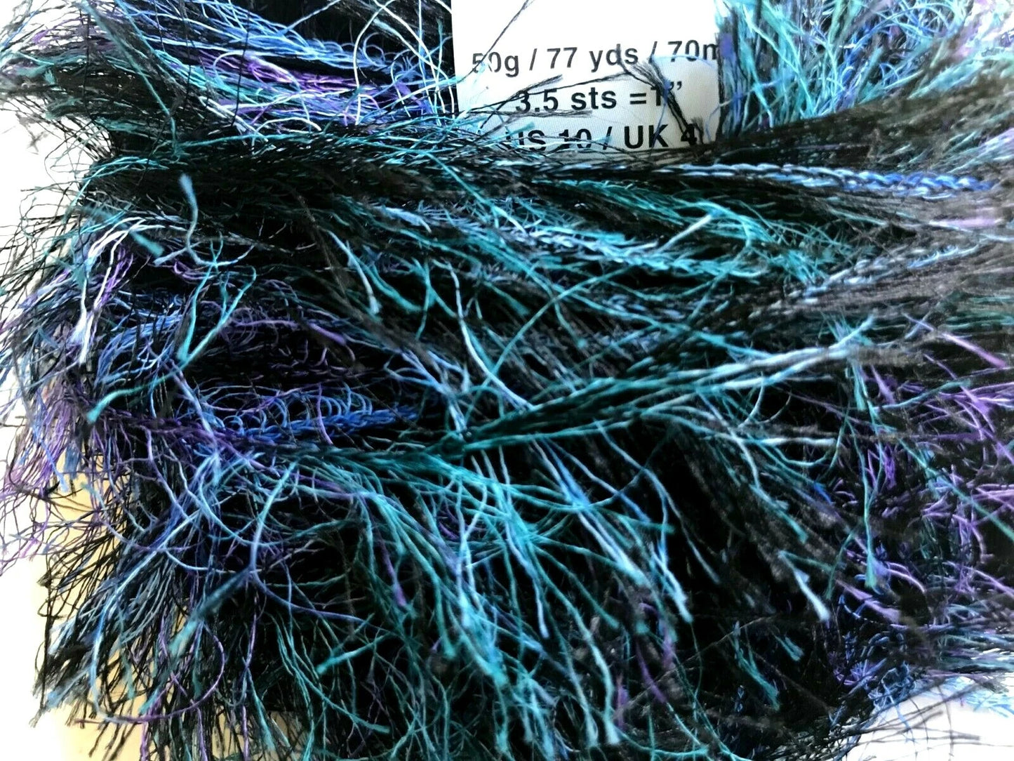 Close-up of a skein of yarn with blue and purple fibers.