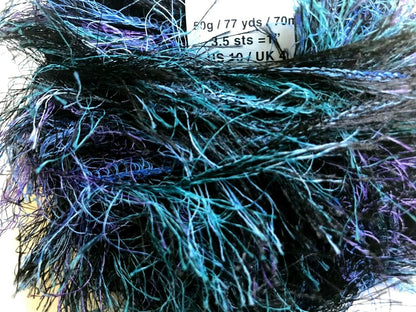 Close-up of a skein of yarn with blue and purple fibers.