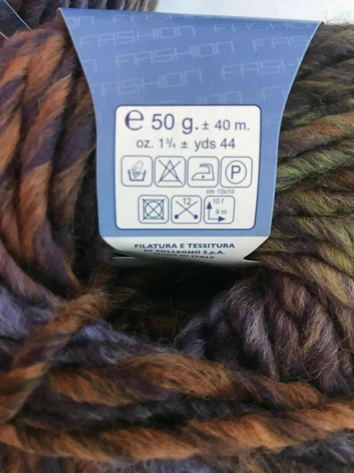 Ball of yarn with a label showing weight and care instructions.