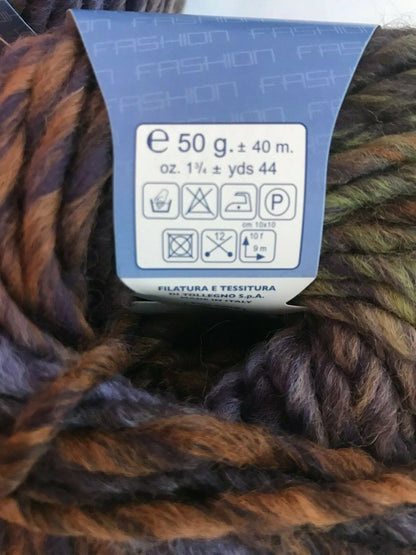 Ball of yarn with a label showing weight and care instructions.