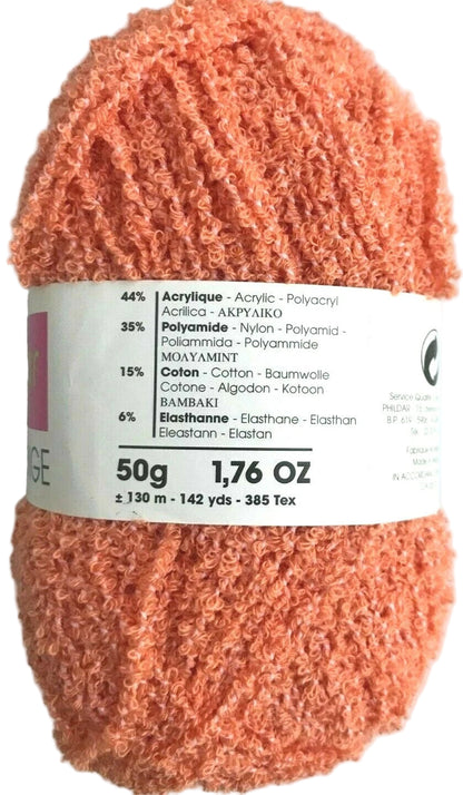 Peach-colored yarn skein with a label on a white background