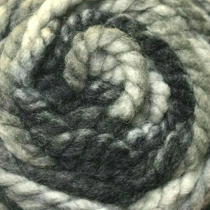 Coiled skein of gray and white yarn on a white background