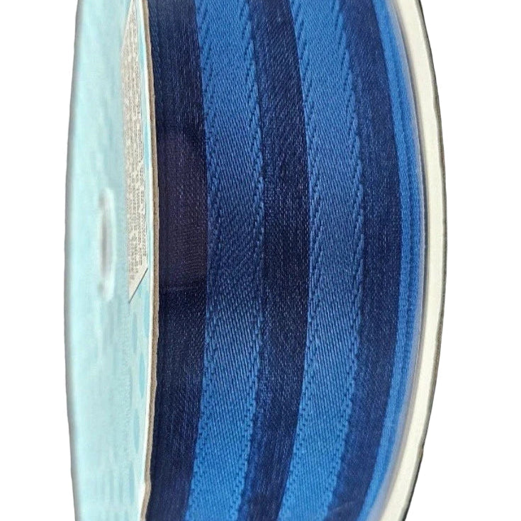 Glass vase with blue and white striped pattern on a white background