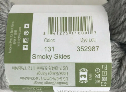Yarn label with product details on a gray yarn background