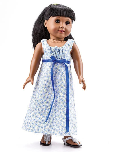 Doll wearing a blue and white floral dress with a blue ribbon on a white background