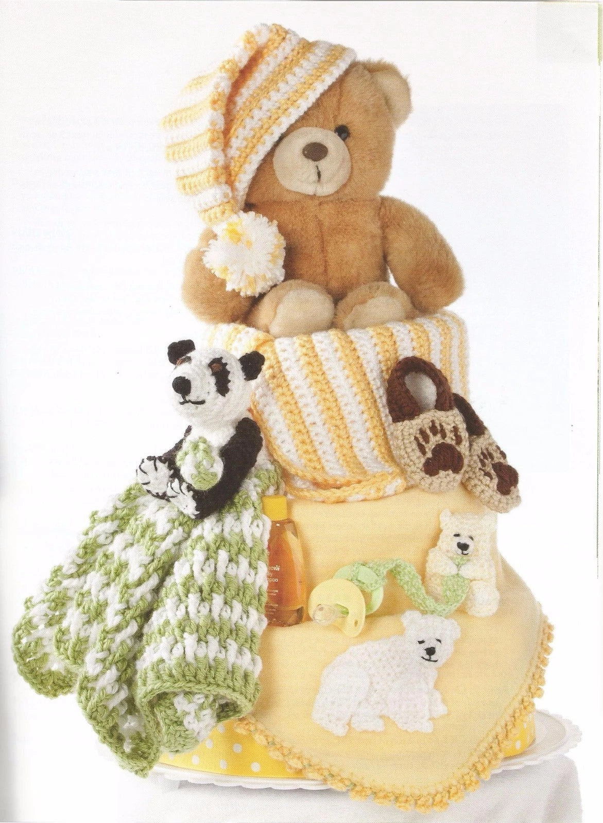 Stack of baby items including a teddy bear, panda, and other plush toys on a white background