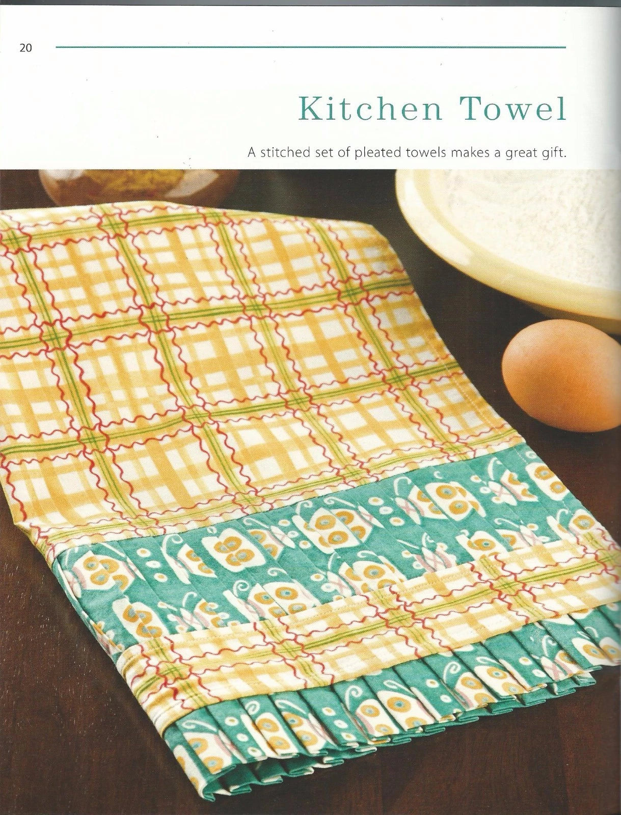 Colorful patterned kitchen towel on a wooden surface with text about it being a great gift.