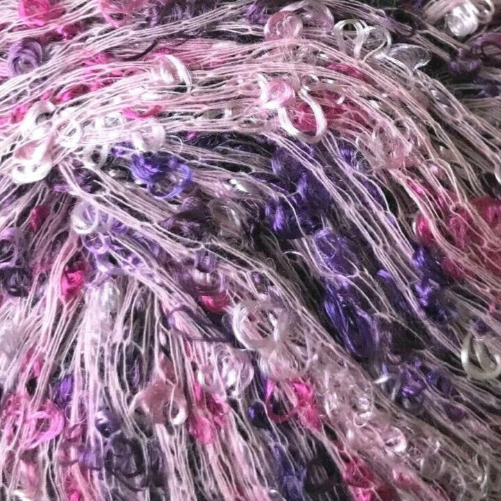 Multicolored yarn ball with a visible brand label on a white background