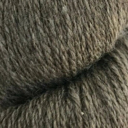 Close-up of a skein of brown yarn on a white background