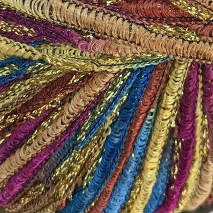 Close-up of multicolored braided yarn with gold, blue, purple, and red tones.