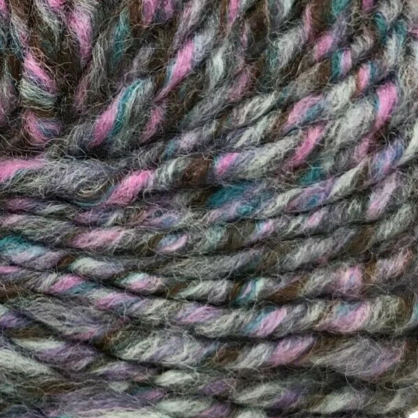 Multicolored skein of yarn with a label on a white background