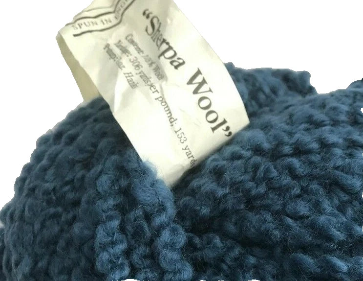 Blue yarn ball with a label on a white background