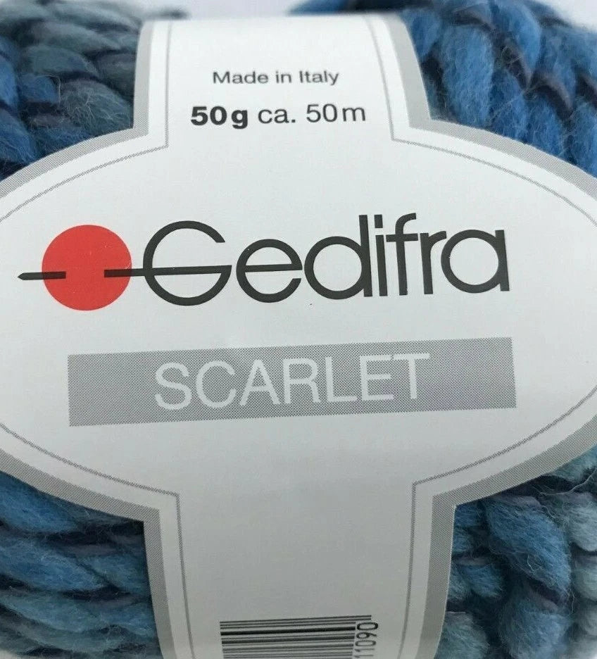Gedifra Scarlet yarn ball with label on a blue yarn background