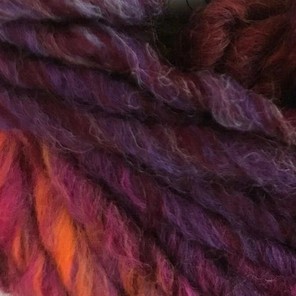 Close-up of multicolored yarn with shades of purple, red, and orange.