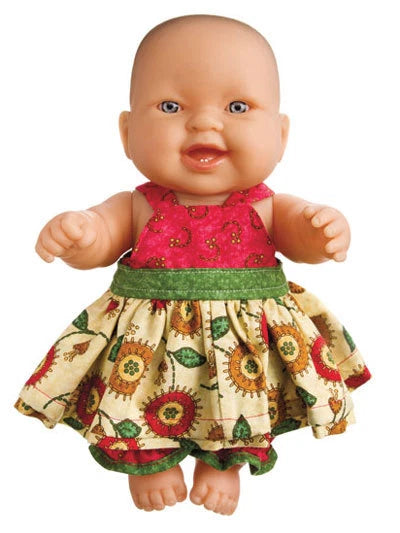 Baby doll wearing a colorful dress on a white background