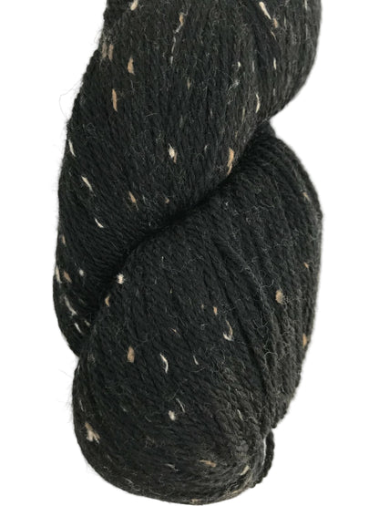 Black yarn skein with white speckles on a white background