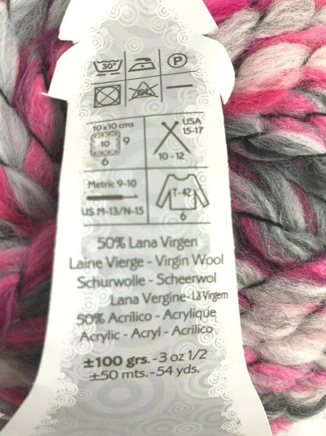 Yarn label with care instructions on a ball of pink and gray yarn.