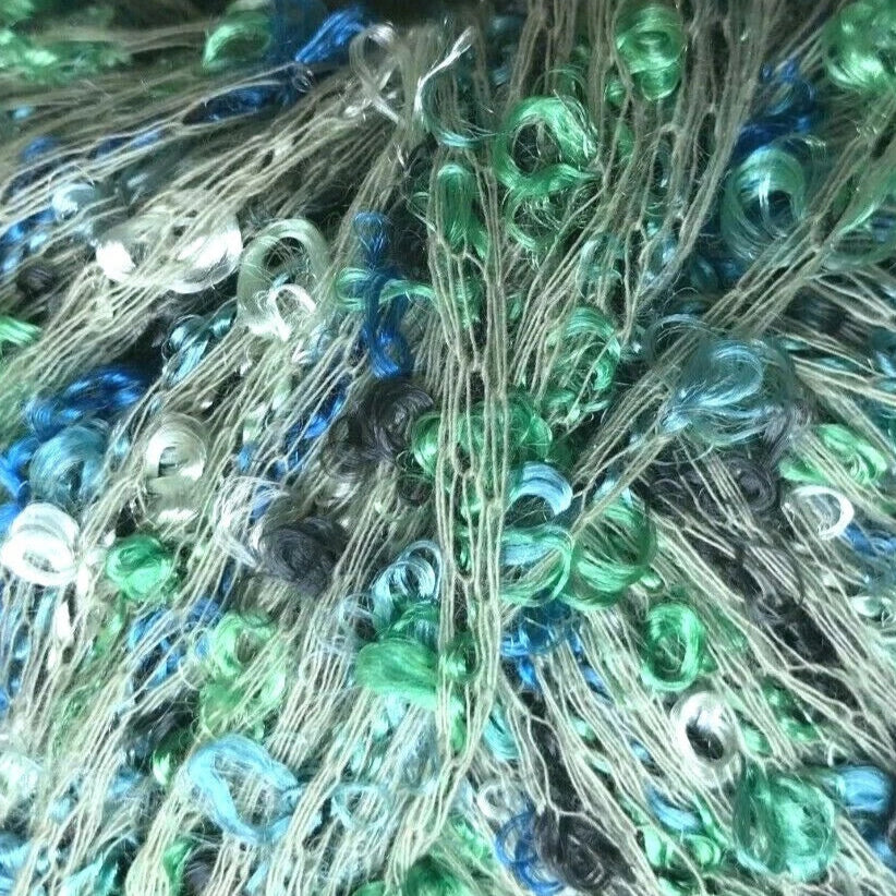 Bunch of colorful beaded thread with a needle on a white background