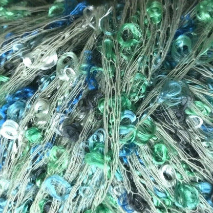 Bunch of colorful beaded thread with a needle on a white background