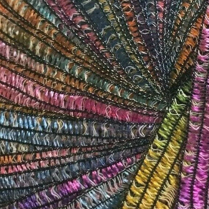 Multicolored yarn ball with a textured pattern on a white background