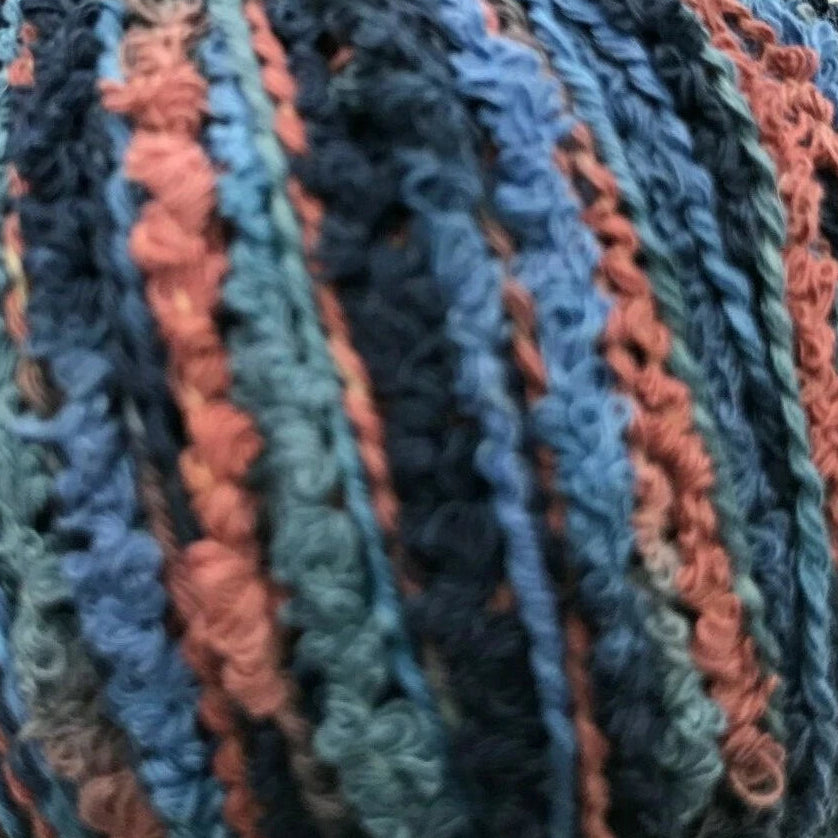 Multicolored skein of yarn with blue, orange, and black stripes on a white background