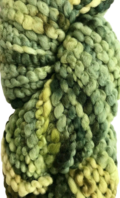 Three skeins of green yarn with a textured pattern on a white background