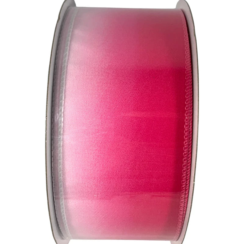 Spool of pink ribbon on a white background